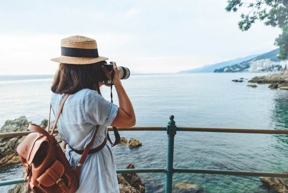 woman taking picture on big camera sea summer vacation